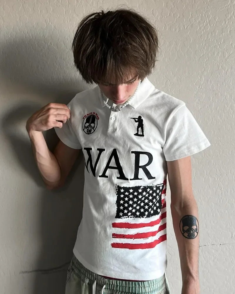 Navy blue polo shirt with red and white graphic design on a gray surface