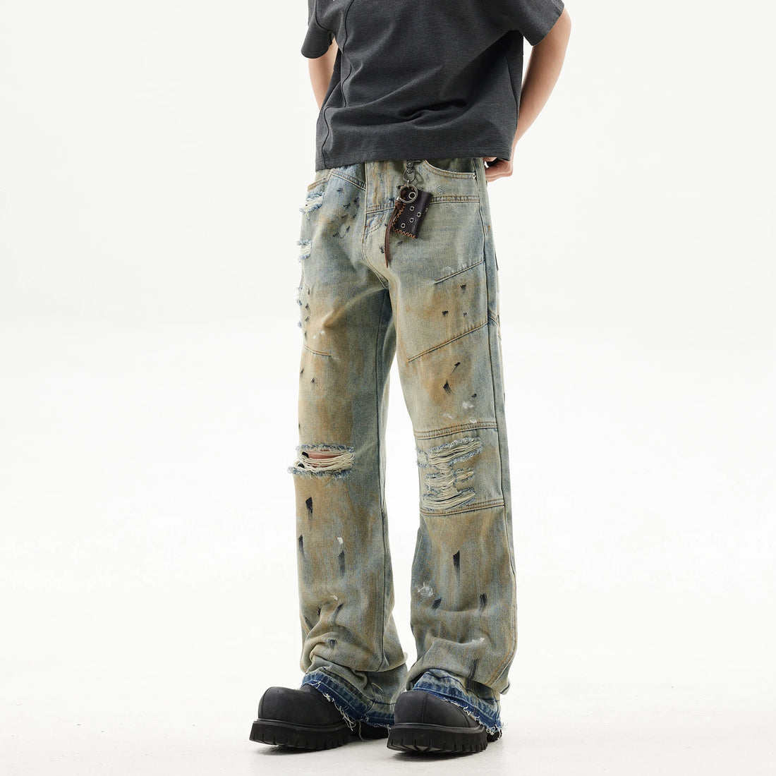 Distressed light blue jeans on a white background